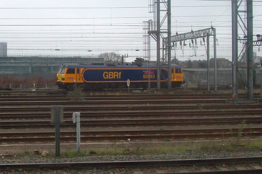 92043, stabled, Wembley Yard 
 On hire to Caledonian Sleeper GBRf's 92043 'Andy Withers 50 Year Service stands in Wembley Yard. According to RTT the locomotive had worked the up 1M16 Sleeper earlier that morning. I have said it before, but I think that this livery really suits these immensely complex and powerful locomotives. 
 Keywords: 92043, stabled, Wembley Yard Andy Withers 50 Year Service