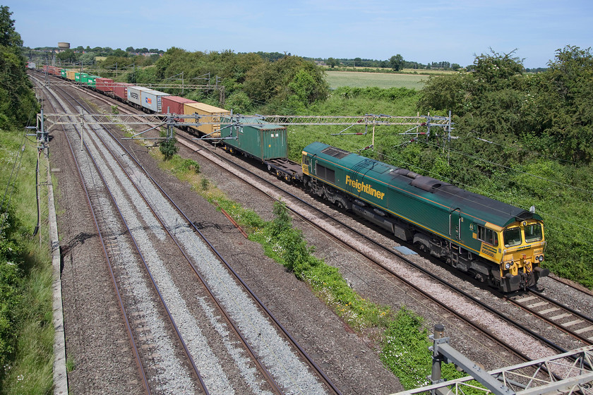 66550, 12.28 DIRFT-Wembley Yard (4A91), Victoria Bridge 
 Freightliner 66550 heads the 12.28 Daventry International Railfreight Terminal (DIRFT) to Wembley Yard working past Victoria Bridge just north of Hanslope Junction. I just had time to get home from here on this glorious summer's day to catch England beat Panama 6-1 in the World Cup group match. 
 Keywords: 66550 12.28 DIRFT-Wembley Yard 4A91 Victoria Bridge