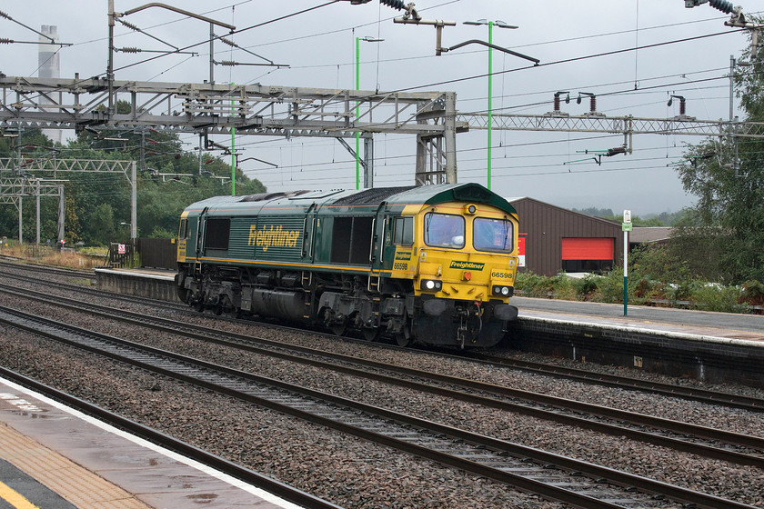 66598, 15.13 Toton North Yard-Crewe Basford Hall, Rugeley Trent Valley station 
 Following hot on the heels of a Euston to Crewe London Northwestern service 66598 passes through Rugeley Trent Valley station as the 15.13 Toton North yard to Crewe Basford Hall light engine move. A friend, who has access to TOPS, was unable to identify the working number of this loco. movement, if anybody can fill in the gap I would appreciate it. 
 Keywords: 66598 15.13 Toton North Yard-Crewe Basford Hall Rugeley Trent Valley station