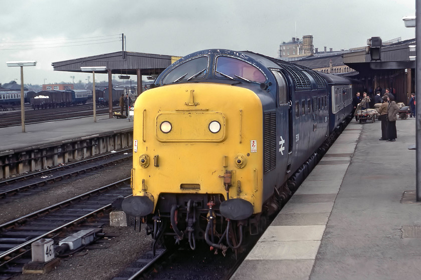 55018, 14.40 Berwick-upon-Tweed-London King`s Cross (1E14), York station 
 55018 'Ballymoss' waits at a busy York station leading the 1E14 14.40 Berwick to London King';s Cross service. Look at all the trolleys on the platform piled with mail bags ready to be loaded on to the Mk. II BSO or BFK marshalled behind the locomotive. Ballymoss' final working was on 12.10.81 when it experienced an engine failure (low air pressure) at Doncaster hauling the 1D08 19:40 King's Cross to Hull. One of its engines was donated to 55007 'Pinza' to keep that locomotive going almost to the end until, ironically, that also experienced engine failure Doncaster on 30.12.81; I wonder if it was the same engine that failed? 
 Keywords: 55018 14.40 Berwick-upon-Tweed-London King`s Cross 1E14 York station