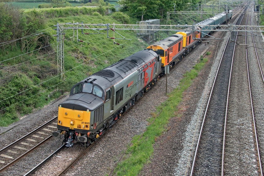 37800, 20311 & 20314, 12.08 Wolverton works-Leicester LIP (5M59, 42L), Victoria bridge 
 Having towed a Class 442 from Eastleigh early in the morning and having deposited it at Wolverton Works, 37800 'Cassiopeia' gets underway again returning to its base at Leicester. Quite why it is towing 20311 and 20314 I am not sure but if anybody can enlighten me that would be useful! Behind the trio of locomotives are four ancient Mk.1 coaches that were used as barrier vehicles when dragging the Wessex electric earlier. The staff at Wolverton Works had to get a move on in order to release this train as another one was bearing down on it to enter the works and if they were not careful this would foul the down fast, see.... https://www.ontheupfast.com/p/21936chg/29028474804/x323210-11-05-soho-lmd-wolverton In addition to these two trains into Wolverton, another one left later in the afternoon. Looks like that they have plenty of work on! 
 Keywords: 37800 20311 20314 12.08 Wolverton works-Leicester LIP 5M59 Victoria bridge Cassiopeia ROG Rail Operations Group Pheonix