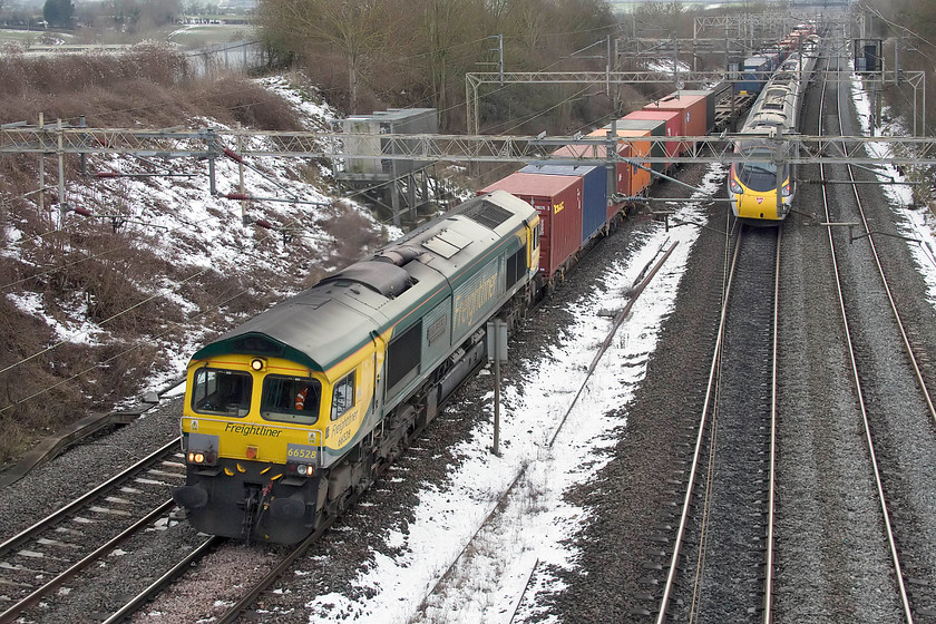 66528, 09.25 Southampton-Garston (4M28) & class 390, VT 13.50 Birmingham New Street-London Euston (1B52, 7L), Victoria bridge 
 I was mighty pleased to see this train come around the corner in the far distance as it meant I could get going as, by now, the cold had really begun to get to my extremities! 66528 'Madge Elliot MBE-Borders Railway Opening 2015' leads the 09.25 Southampton to Garston 4M28 Freightliner past Victoria bridge between Northampton and Milton Keynes. Meanwhile, a class 390 speeds south forming the 13.50 Birmingham to Euston. Right then, let's get home for a cuppa! 
 Keywords: 66528 09.25 Southampton-Garston 4M28 class 390 13.50 Birmingham New Street-London Euston 1B52 Victoria bridge