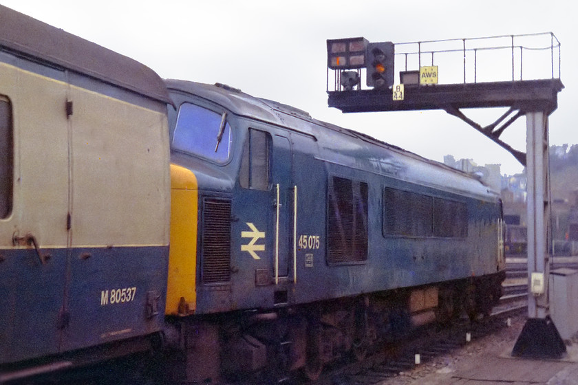 45075, unidentified down working, Bristol Temple Meads station 
 45075 draws away from Bristol Temple Meads station with an unidentified working for the west of England. Just behind the train in the direction of view was the Bristol Bath Road depot. At this time it was a home for many classes. You could spend a few hours at this spot watching the many comings and goings as engines came off and went on shed as Bristol was still traditionally used as a location for an engine change, a situation that harked back to steam days. 
 Keywords: 45075 Bristol Temple Meads station