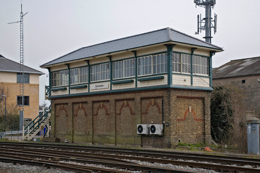 Chichester signal box (LBSC, 1882) 
 Chichester signal box is a fine and imposing example of a London, Brighton & South Coast Railway structure built in 1882. It is only one of two Saxby & Farmer Type 5 signal boxes still extant the other being Eastbourne which I visited a few years ago. The box contains an NX panel and has been a little modified from its original design by, for example, the bricking up of the round-headed locking room windows and the more recent installation of UPVC double-glazing units. The twin air conditioning units are not particularly subtle additions either! 
 Keywords: Chichester signal box LBSC