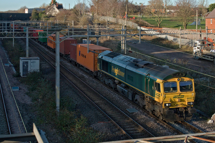 66957, 12.16 Lawley Street-London Gateway (4L46, 2L), site of Roade station 
 The highest numbered member of the four hundred and fifty-five Class 66s passes through Roade. Freightliner's 66957 'Stephenson Locomotive Society 1909-2009' leads the 4L46 12.16 Lawley Street to London Gateway just catching some winter sunshine on its front end. The tall white building to the top of the photograph is the former station master's house. 
 Keywords: 66957 12.16 Lawley Street-London Gateway 4L46 site of Roade station Stephenson Locomotive Society 1909-2009