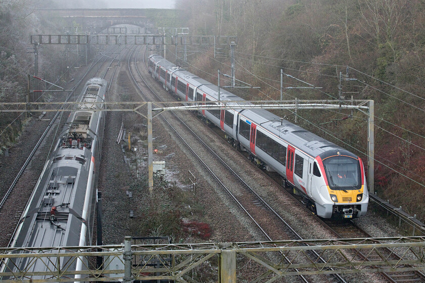 720116, 11.56 Rugby-Wembley IC Depot (5Q28, RT) & 390047, VT 10.43 Liverpool Lime Street-London Euston (1A20, 21L), A508 bridge 
 Even on Sundays, the testing of new stock continues! As Avanti's 390047 heads south Greater Anglia branded 720116 is seen passing Roade as the 11.56 Rugby to Wembley Inter City Depot 6Q28 mileage accumulation run. The train had run north earlier in the morning but was running extremely late so was capped at Rugby rather than running further to Nuneaton before returning south again. These five-car 720/1 units have already started to enter service on the GA network and will be offering a step change from the old mixture of hand-me-down units that passengers have to use. 
 Keywords: 720116 11.56 Rugby-Wembley IC Depot 5Q28 390047 10.43 Liverpool Lime Street-London Euston 1A20 A508 bridge Greater Anglia AWC Avanti West Coast Pendolino