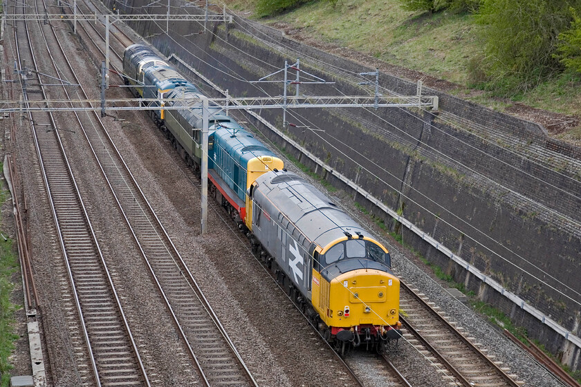 37901, 20087, 47402, 33109 & 55009, 08.52 Alton-Castleton Hopwood (0Z20), Roade cutting 
 I could not resist a going-away shot of the 0Z20 08.52 Alton to Castleton (East Lancashire Railway) light engine(s) move. With 55009 'Alycidon' under power and leading the collection 33109 'Captain Bill Smith RNR' is second from the front. From the rear is 'heavyweight' 37901, 20087 and then 47402. All the locomotives had been involved in the excellent Mid Hants. diesel gala the previous weekend. 
 Keywords: Captain Bill Smith RNR 37901 20087 47402 33109 55009 08.52 Alton-Castleton Hopwood 0Z20 Roade cutting Alycidon