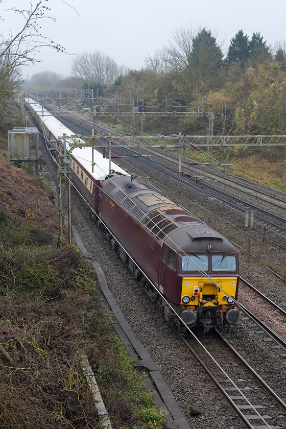 57314, the outward leg of the Northern Belle, 07.58 Chester-London-Euston (1Z41), Victoria bridge 
 47314 brings up the rear of the Northern Belle excursion as it passes Victoria bridge just south of Roade. The excursion left a dank and dismal Chester at 07.58 and arrived at an equally dreary Euston at lunchtime, such was the weather that shrowded the country on this November weekend. The awful WCR livery that now adorns 57314 is probably the worst it has worn since being re-built from 47372 in April 2004. Initially, it was one of Virgin's Thunderbirds and then became one of ATW's turquoise locomotives that led their north-south Wales 'Super Train'. 
 Keywords: 57314 Northern Belle, 07.58 Chester-London-Euston 1Z41 Victoria bridge