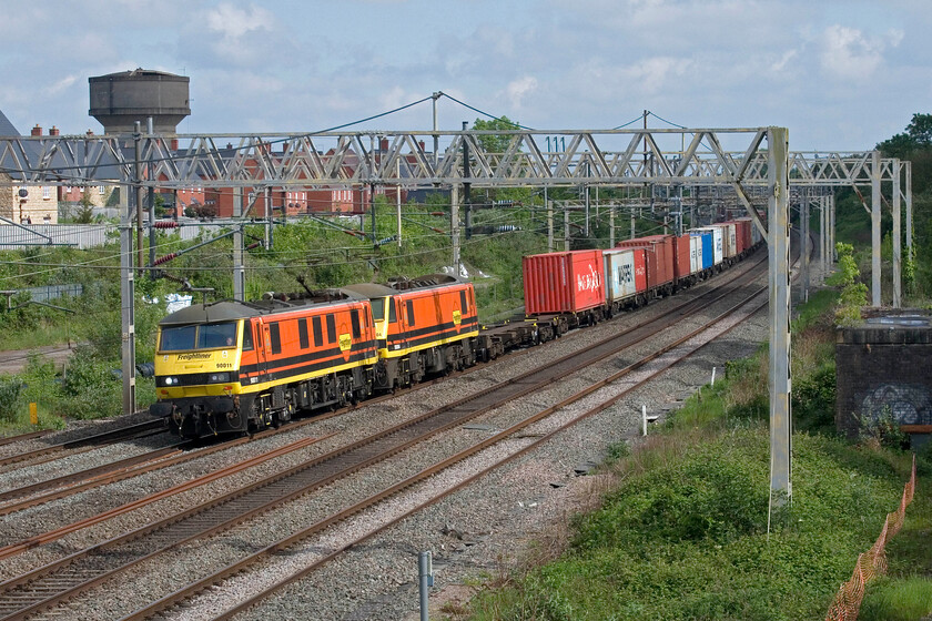 90011 & 90004, 11.13 Felixstowe North-Ditton (4M87, 3E), site of Roade station 
 A pair of matching Freightliner 
 Keywords: 90011 90004 11.13 Felixstowe North-Ditton 4M87 site of Roade station Freightliner Class 90s make a pleasing sight as they pass through Roade in some welcome spring sunshine. 90011 and 90004 lead the daily 4M87 11.13 Felixstowe to Ditton service which is usually double-headed.