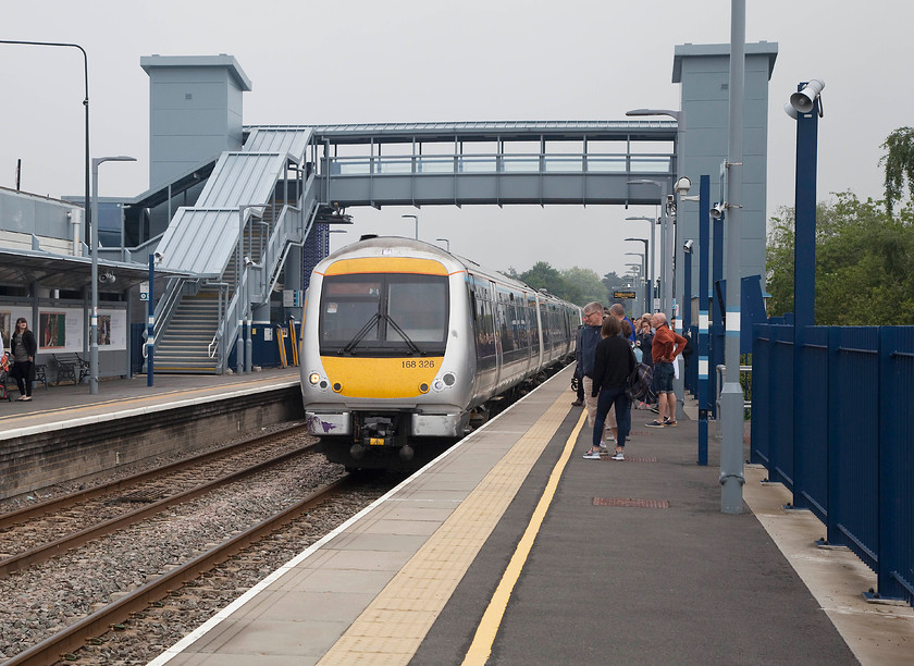 168326, CH 10.06 London Marylebone-Oxford (1T21, 7L), Bicester Village station 
 168326 arrives into Bicester Village (formally Town) station forming Chiltern Railway's 10.06 London Marylebone to Oxford working. Dominating this view is the huge footbridge containing full sized lift towers to accommodate the huge numbers of shoppers who use this station that has its own dedicated entrance in to the Bicester Village complex. I travelled on this train to Oxford with my Brompton bike folded up. Despite being a mid-morning Saturday working the train was absolutely packed. 
 Keywords: 168326 1T21 Bicester Village station