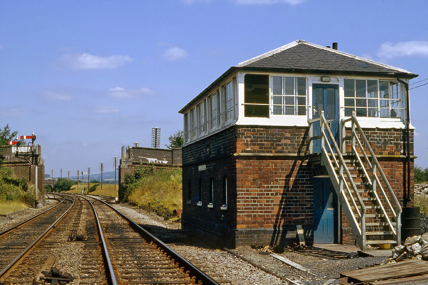 Woofferton Junction signal box (LNW & GW Joint, c.1875) 
 The signalman permitted graham and me access to the track to take this photograph of his box. Wooferton signal box is a LNW & GW structure dating from 1875 and is similar in design to a number of such boxes on this route between Hereford and Shrewsbury. I visited this location a few months earlier to take a photograph of steam-hauled Welsh Marches Express positioning myself at the bridge in the distance, see.... https://www.ontheupfast.com/p/21936chg/30022609709/x6000-welsh-marches-express-10-15 
 Keywords: Woofferton Junction signal box LNW & GW Joint.1875)