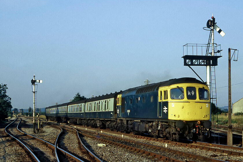 33005 17.20 Cardiff Central-Weymouth, Witham 
 This photograph is a classic demonstration of how badly the chemicals in the Fujichrome film handled the strong and rich evening light. I have had to spend an awful lot of time resurrecting it in Photoshop post-scanning and even then it still demonstrates an odd hue that I have really struggled to remove; I may have another go when I have an hour or so spare! 33005 passes Witham (Somerset) leading the 17.20 Cardiff to Weymouth train. Notice that the final digits of the Crompton's number are written in white paint on the drawbar as was often the case with these Southern Region locomotives. 
 Keywords: 33005 17.20 Cardiff Central-Weymouth Witham