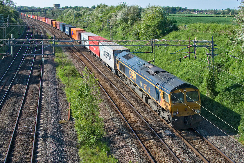 66716, 13.57 Birch Coppice-London Gateway (4L68, 1L), Victoria bridge 
 GBRf's 66716 'Locomotive & Carriage Institution Centenary 1911-2011' is seen passing Victoria bridge between the Northamptonshire villages of Raode and Ashton leading the 4L68 13.57 Birch Coppice to London Gateway afternoon service. As can be seen from this image, the afternoon is glorious now which is in stark contrast to a week previously that saw cold and wet weather that had characterised the previous month making people wonder if spring would ever arrive! 
 Keywords: 66716 13.57 Birch Coppice-London Gateway 4L68 Victoria bridge Locomotive & Carriage Institution Centenary 1911-2011 GBRf