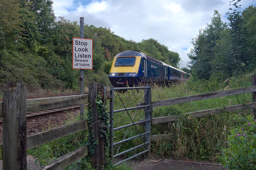 43161, GW diverted 11.12 London Paddington-Cheltenham (1G29), Bradford-on-Avon number 2 crossing 
 The lush green Wiltshire vegetation has really taken over at this location near Bradford-on-Avon as made clear in this view at a foot crossing that leads down to the towns Barton Farm country park. 43161 leads the diverted 11.12 Paddington to Cheltenham First Great Western service away from the town to continue its diverted journey along the delightful Avon Valley to Bathampton Junction. Here it will head west along the Great Western mainline to North Somerset Junction where it will then head northwards taking the Midland route to its destination. 
 Keywords: 43161 diverted 11.12 London Paddington-Cheltenham 1G29 Bradford-on-Avon First Great Western HST