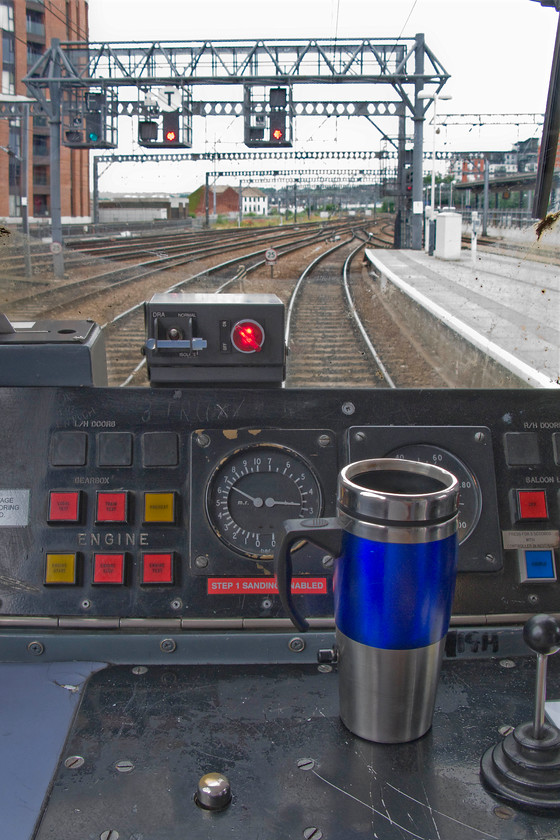 Cab, 144022, NT 12.29 Leeds-York (2C30), Leeds station 
 The driver's desk of 144022 is seen as it the unit waits at Leeds station complete with the driver's cup of tea! It is about to work the 2C30 12.29 to York that will travel the clockwise route via Harrogate. We travelled on this unit bouncing all the way to Knaresborough as the final part of our journey from Northampton. 
 Keywords: Cab 144022, NT 12.29 Leeds-York 2C30)Leeds station