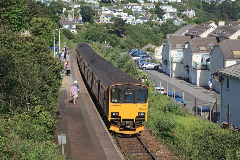 150106 & 150121 GW 08.57 Penzance-St. Ives (2A07, RT), Carbis Bay station 
 With a fair number of passengers waiting at Carbis Bay station to make the short journey to St. Ives, the 08.57 from Penzance comes to a halt. The units are still wearing their FGW livery are 150106 and 150121. It is likely that these units will be leaving the West Country soon as new units are cascaded in with the 150s moving north. 
 Keywords: 150106 150121 2A07 Carbis Bay station