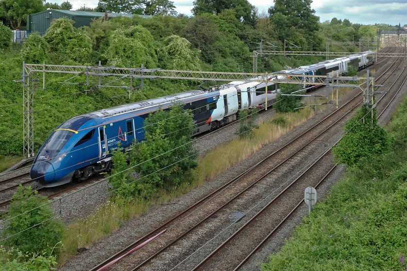 805013, VT 09.20 Chester-London Euston (as 09.44 ex Crewe) (1A19, 8L), Victoria bridge 
 Evero 805013 passes Victoria bridge working the 09.20 Chester to Euston service. Unfortunately, something had obviously gone wrong earlier in the day as the train had actually started from Crewe. I hope that passengers who wanted to catch the train from Chester were able to get to Crewe in time for the journey south. This photograph amply illustrates the uncontrolled growth at this location with several ash trees taking up residence between the slow and fast lines. 
 Keywords: 805013 09.20 Chester-London Euston 09.44 ex Crewe1A19 Victoria bridge Avanti West Coast Evero