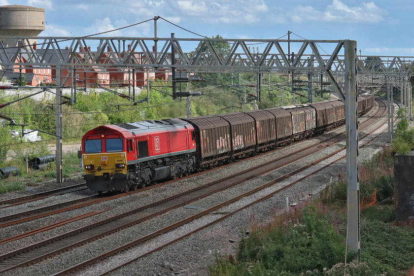 66001, 11.07 Dollands Moor-DIRFT (6M45, RT), site of Roade station 
 Pioneer member of the Class 66 family 66001 passes the site of Roade's former station leading the 6M45 Dollands Moor to Daventry (DIRFT) water train. Twenty-five years ago 66001 arrived on the dockside at Immingham on the morning of 18.04.98 and after a brief period of testing and staff training went into service by July and the rest, as they say, is history! 
 Keywords: 66001 11.07 Dollands Moor-DIRFT 6M45 site of Roade station