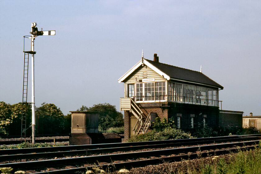 Hessle Haven signal box (NE, 1913) 
 After our fantastic day out in north Lincolnshire (or, tin hat on, south Humberside as it is often referred to today) and taking in the delights of MV Farringford in what was the twilight week of her operations we had a long drive home back to Bath in the Austin 1100! Before setting off in earnest Graham and I paused at Hessle Haven to photograph the lovely North Eastern signal box dating from 1913 just catching the evening light. A little photographed box, it was located just to the east of Hessle station at the point where the lines to both Hessle Hump Yard and Priory Yard diverged. Everything in this area has changed beyond recognition now with just the twin running lines in towards Hull remaining with the whole area comprehensively redeveloped including the huge A63 Clive Sullivan Way trunk road to the right of this view. 
 Keywords: Hessle Haven signal box