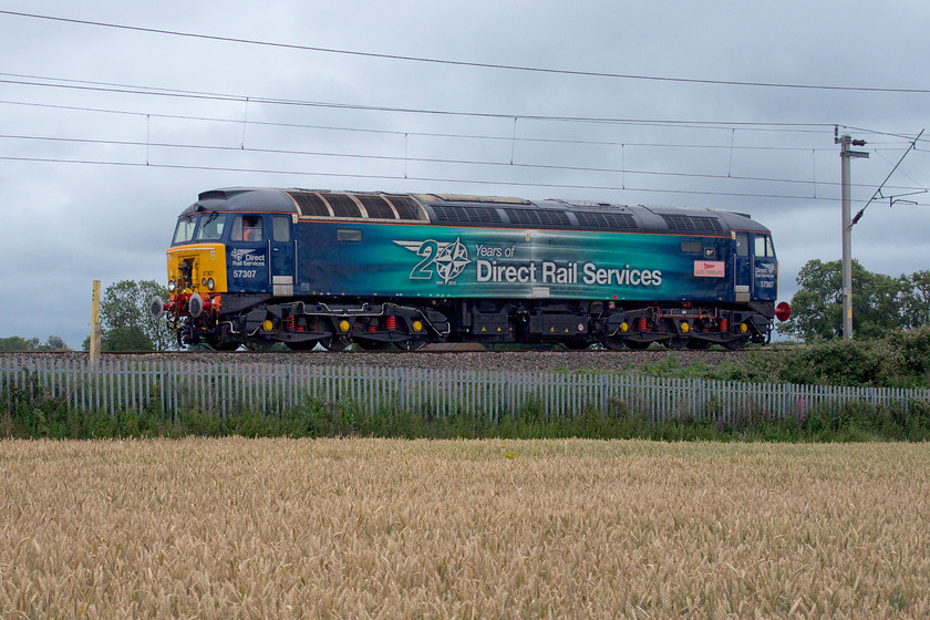 57307, unidentified working (0Z99), Milton Malsor SP738556 
 I had spotted the 0Z99 working on OpenTrainTimes making its way down the slow on the WCML not knowing quite what it was until a fellow photographer informed me that it was a Class 57 Thunderbird move. However, when it reached Hanslope Junction it was held on a red and looked as if it was going to be put on the fast line thus making a photograph impossible as we were at Milton Malsor on the Northampton loop. Consequently, I set off back to the van to get on with my day. I just so happened to check my phone as I was nearly back and saw that it had reverted back to the slow and that it was just one signal away from where I was! I stopped in the middle of the field that I was crossing, set the camera up, and there it was. The photograph was probably a better one than would have been taken where I was a little earlier as it was a light engine. If anybody has any information as to what this working was please could you get in contact with me. In another guise back in 1980 I photographed this Class 57 as 47225, see..... https://www.ontheupfast.com/p/21936chg/29477846804/x47225-23-40-glasgow-plymouth-1v57 
 Keywords: 57307 unidentified working 0Z99 Milton Malsor SP738556 Thunderbird Lady Penelope DRS Direct Rail Services