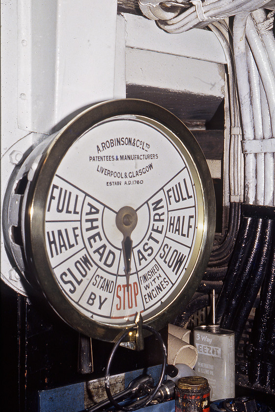 MV Farringford, engine order telegraph, engine room 
 The engine room's order telegraph is seen, like everything else on the MV Farringford, looking spic and span with its polished brass bezel. A. Robinson and Co. LTD of Liverpool and Glasgow were a manufacturer of all types of deck products for ships and their items today, such this one, that has been recovered from ships attract premium prices in the collectors market. Notice the can of EEZIT oil next to the tools and a tin of Swarfega that looks like it may contain something else? EEZIT still exist today but in the specialist lubricant market and is not the same as the far better-known 3-in-One oil that we are more familiar with. 
 Keywords: A. Robinson and Co. LTD MV Farringford, engine order telegraph engine room