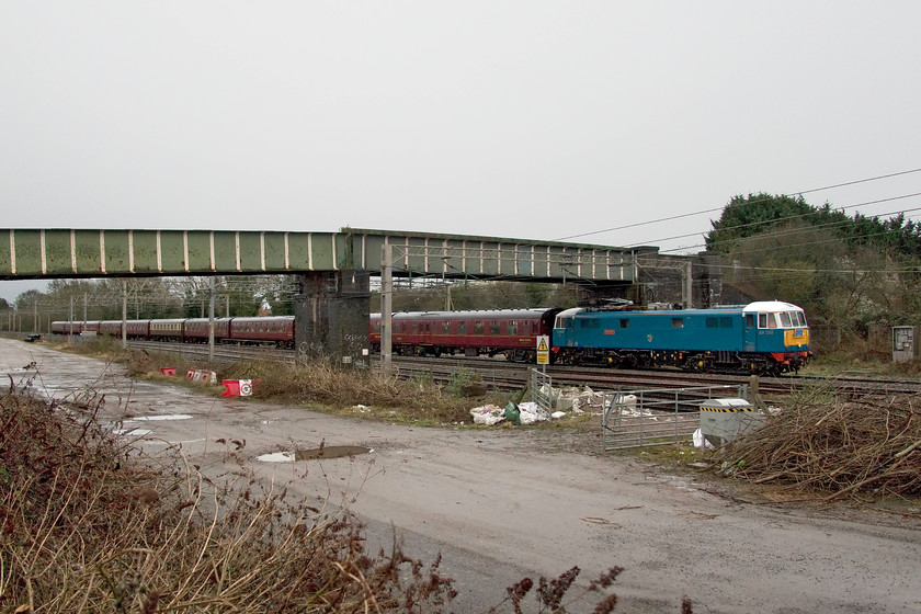 86259, outward leg of The Cumbrian Mountain Express, 07.10 London Euston-Carlisle (1Z86, RT), site of Roade station 
 I have seen very little of 86259 'Les Ross/Peter Pan' this winter season on the 'Cumbrian Coast and Cumbrian Mountain Express' as it has not been running anywhere as frequently as it has in previous years. Running with the customary 1Z86 reporting number and leaving Euston at 07.10 for Carlisle with a change to steam at Carnforth it is seen passing the site of Roade station on this grey and dour February leap day morning. 
 Keywords: 86259 Les Ross Peter Pan The Cumbrian Mountain Express 07.10 London Euston-Carlisle 1Z86 site of Roade station