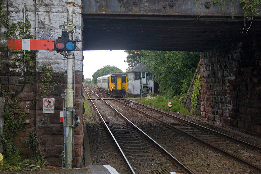 156491, NT 15.12 Carlisle-Barrow-in-Furness (2C32, 8L), Millom station 
 156491 approaches Millom station passing the 1891 Furness signal box working the 15.12 Carlisle to Barrow-in-Furness Northern service. Notice the shunting disc signal for the rarely used crossover. The disc has a small diamond indicating to drivers that track circuits are in operation. 
 Keywords: 156491 15.12 Carlisle-Barrow-in-Furness 2C32 Millom station northern