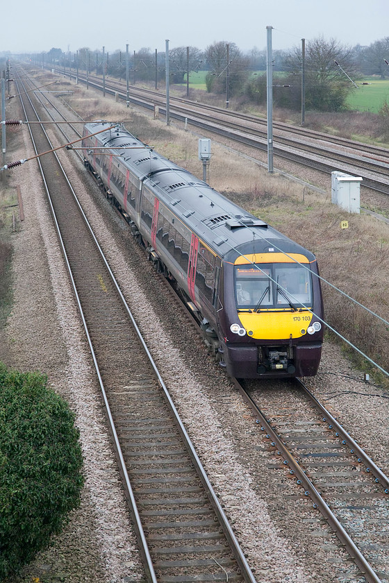 170103, XC 07.10 Gloucester-Stansted Airport (1L00, 6L), Marholm TF154036 
 This is a real Cross Country cross-country working! The 07.10 Gloucester to Stansted Airport drifts on the up slow preparing for its Peterborough stop past Marholm formed of 170103. This picture is taken from the large footbridge that spans the five lines of the ECML at this point. This bridge replaced a level crossing that required the road, as a through route, to be closed. The bridge has become a well known and popular spot with train photographers. 
 Keywords: 170103 1L00 Marholm TF154036