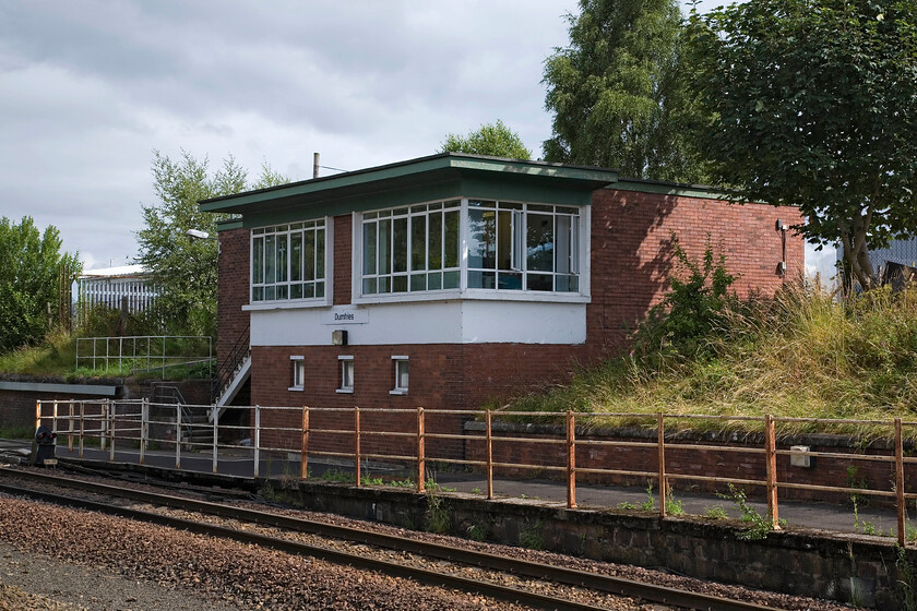 Dumfries signal box (BR ScR, 1957) 
 The British Railways (Scottish Region) built signal box at Dumfries is an interesting structure partially built into the bank behind. It was opened in 1957 but I know nothing about the box it replaced or the reason why...local knowledge anybody? I do know that the box is in between Annam (to the east) and Holywood (to the north) boxes and that it contains a small NX panel. 
 Keywords: Dumfries signal box BR ScR