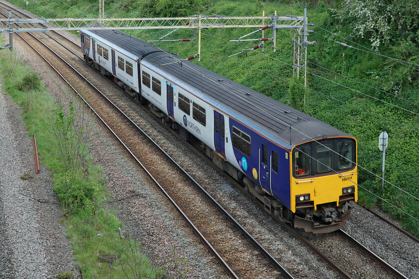 150111, 08.12 Newton Heath TMD-Wolverton Centre Sidings (5H70, RT), Victoria bridge 
 Unfortunately, just missing out on a bit of sunshine Northern's 150111 approaches journey's end at Victoria Bridge just south of Roade. Running as 5H70 the unit left Newton Heath Depot at 08.12 for a visit to Wolverton Works. Wolverton has been receiving regular visits from units from various TOCs in recent months for various upgrades and repairs. On talking to an employee of the Works it is clear that the main issue with these ageing units is corrosion to the floors particularly under the vestibule areas. 
 Keywords: 150111 08.12 Newton Heath TMD-Wolverton Centre Sidings 5H70 Victoria bridge Northern