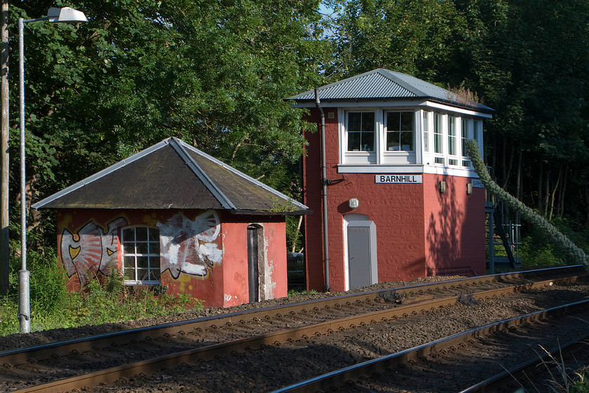 Barnhill signal box (Caledonian, 1874) 
 The 1874 Caledonian signal box at Barnhill is a little tricky to get to and even more so to get a decent photograph of! It is an important point to the east of Perth where the double track from Dundee singles to permit trains to pass the twin Perth River Tay viaducts. Even in this location that is awkward to access, the graffiti vandals have done their worst on the walls of the Caledonian hut. 
 Keywords: Barnhill signal box Caledonian