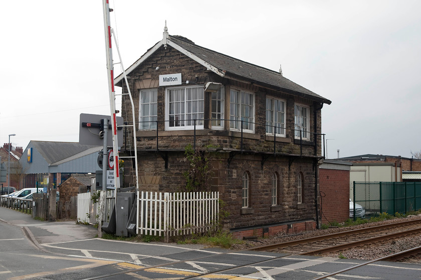 Malton signal box (NE, c.1873) 
 A signal box that I have passed many times but never actually have taken a picture of is here at Malton. It sits a short distance east of the station at a busy level crossing with a road junction at either side of the line. Indeed, getting a picture with no cars in the shot took a minute or two! The box is a lovely example of a North Eastern S1a type design dating from circa 1873 and is in superb and un-molested condition. It controls no semaphores but contains a relatively early 1966 IFS (Individual Function Switch) that was extended in 1993. When it was first installed, two other local boxes, Malton West and Malton Station boxes were abolished. Today, the box still works absolute block east to Weaverthorpe and west to Kirkham Abbey. 
 Keywords: Malton signal box