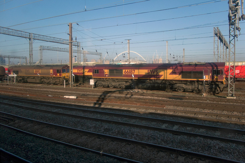 66143 & 66187, stabled, Wembley yard 
 A trio of class 66s are seen stabled in Wembley yard between duties. To the right is 66187 and the left 66143. The latter is still wearing the filth from its times when it was being used on railhead treatment trains with just the area around the number and cab ends being cleaned, see.... https://www.ontheupfast.com/v/photos/21936chg/28348130404/x66143-11-53-west-hampstead-north 
 Keywords: 66143 66187 Wembley yard