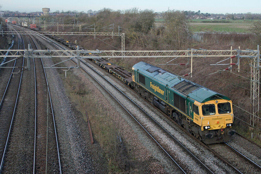 66585, 09.55 Crewe Basford Hall-Southampton MCT (4O35, 42E), Victoria bridge 
 With the front, ten or so Freightliner wagons being unloaded 66585 leads the 09.55 Crewe Basford Hall to Southampton MCT passes Victoria bridge just south of Roade. I was pleased to be able to record this rather anonymous Freightliner locomotive as it has appeared to evade my camera over the years thus being a photographic cop! 
 Keywords: 66585 09.55 Crewe Basford Hall-Southampton MCT 4O35 Victoria bridge Freightliner