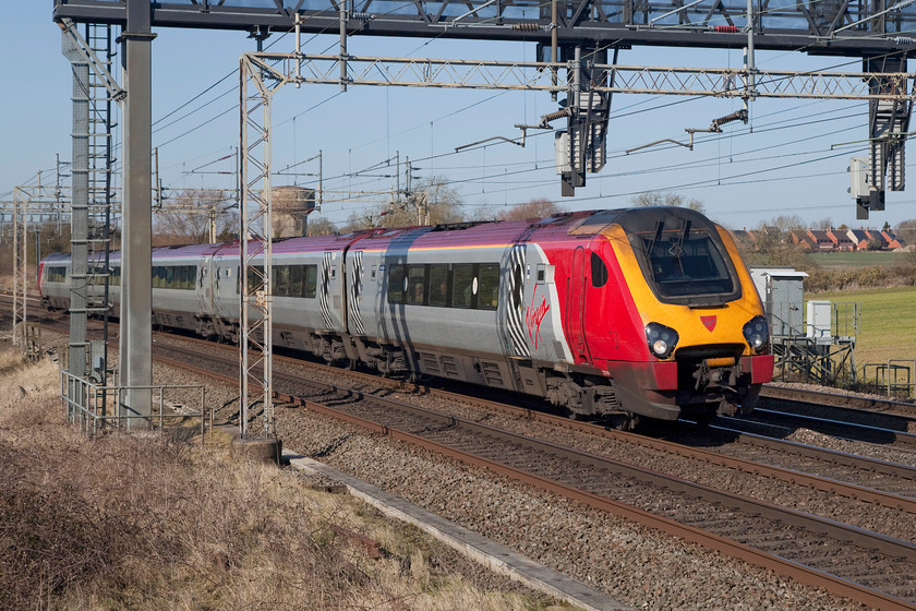 221101, VT 11.28 Chester-London-Euston (1A19, 17L), Roade Hill 
 This Super Voyager was just pulling away from the red signal on the gantry above it at Roade Hill on the southern WCML. It had been sitting at this red light for some ten minutes as all workings were held up due to a problem some 7 miles south in the Milton Keynes area. 221101 'Louis Blriot' was working the 11.28 Chester to London Euston where it arrived 17 minutes late. 
 Keywords: 221101 Louis Blriot 1A19 Roade Hill