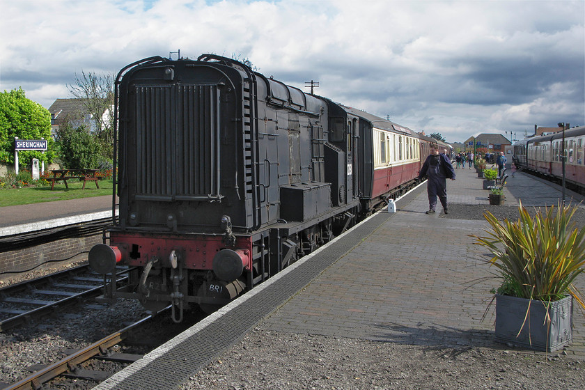 12131, removing Gresley bar coach, Sheringham station 
 With the 12.45 Holt to Sheringham service having arrived at its destination North Norfolk Railway staff set about to remove the Gresley buffet attached to the rear of the stock. The staff are using resident shunter 12131. Built in 1952 at Darlington and designated as a Class 11 this particular example arrived on the NNR in 1982 after being sold by the National Coal Board following the closure of the Snowdown colliery in Kent. 
 Keywords: 12131 Gresley bar coach Sheringham station NNR North Norfolk Railway Poppy Line