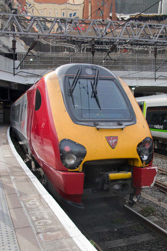 221116, VT for 15.24 Shrewsbury-London Euston (1B68), Birmingham New Street station 
 Despite having its tail lights illuminated, this Voyager, 221116 'City of Bangor/Dinas Bangor' will soon work forwards to Euston as the 15.24 Shewsbury to Euston. That is when it is joined by the incoming unit from the Shropshire county town that will be attached to the rear forming the double-set service from here at New Street; how complicated! 
 Keywords: 221116 for 15.24 Shrewsbury-London Euston (1B68), Birmingham New Street station Virgin trains voyager City of Bangor / Dinas Bangor