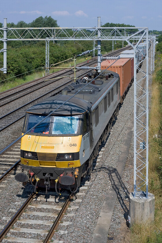 90048, 08.21 Crewe Basford Hall-Felixstowe North (4L93), Bradwell SP831391 
 90048 is crawling along the up slow line at walking pace at Bradwell in Milton Keynes behind a local service and a Northern Belle charter that had just passed. The AC electric is leading the 4L93 08.21 Crewe Basford Hall to Felixstowe Freightliner service. 
 Keywords: 90048 08.21 Crewe Basford Hall-Felixstowe North 4L93 Bradwell SP831391 Freightliner