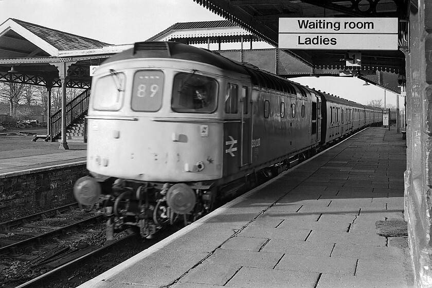 33020, unidentified Cardiff Central-Portsmouth Harbour working, Trowbridge station 
 Apologies for the poor quality of the image blighted by motion blur. Usually, this image would not have made the cut but I have very few photographs of the old Trowbridge station despite it being local to me living near to Bradford-on-Avon. This superb station, which was a modeller's delight, was tragically razed to the ground in a wanton act of vandalism inflicted by BR in 1987. It was claimed that the station was structurally dangerous and almost overnight without due agreement it was reduced to a pile of rubble. The footbridge seen in the background of this image was the only thing saved now being in use at Wiliton station on the West Somerset Railway. 33020 is the identified locomotive leading an unidentified service that I suspect was a Cardiff to Portsmouth Harbour train. 
 Keywords: 33020 Cardiff Central-Portsmouth Harbour working Trowbridge station