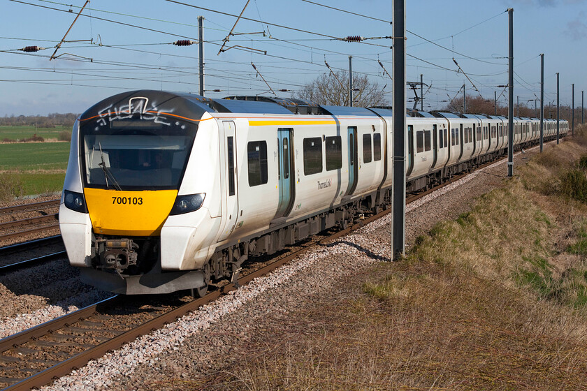 700103, TL 09.55 Peterborough-Horsham (9J21, 3L), Sandy TL176510 
 The graffiti vandals have been doing their best to spoil the front of 700103 that is seen approaching Sandy working the 09.55 Peterborough to Horsham service. I am not at all sure if the vandals will have realised the potential danger that they may well have been in being so high up and near to the OLE attacking the cab roof as they have done. 
 Keywords: 700103 09.55 Peterborough-Horsham 9J21 Sandy TL176510