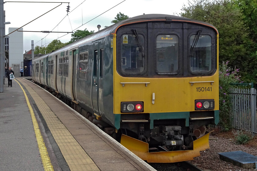 150141, LN 06.42 Bletchley-Bedford (2S03, 2E), Bedford station 
 When I last photographed 150141 it was in a very different location to here at Bedford, see.... https://www.ontheupfast.com/p/21936chg/23847805404/x150141-150271-2n27-preston-station The legacy of its former operator, Northern, can be seen on the flanks of the unit just after it has arrived with the terminating 2S03 06.42 from Bletchley with the graphics forming the majority of its livery with just a nod towards London Northwestern (or West Midlands Trains) towards the front. At least trains are finally operating on the Marston Vale route again after many, many months of bustitution; a shocking state of affairs. 
 Keywords: 150141 06.42 Bletchley-Bedford 2S03 Bedford station