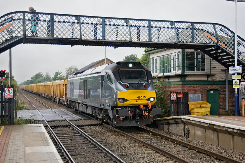 68015, 08.59 Crewe Basford Hall-Mountsorrel (6U76), Narborough station 
 After the passage of a westbound Class 170 a few minutes earlier, the level crossing barriers stayed down causing yet more congestion on Narborough's busy Station Road. A few minutes later, Chiltern liveried 68015 passed through the station with the 08.59 Crewe Basford Hall to Mountsorrel. Unfortunately, I have not quite positioned the train quite correctly but I wanted to include the now closed signal box in the composition. I should have pressed the shutter a split second earlier with the locomotive just on the level crossing; you can't win them all! 
 Keywords: 68015 08.59 Crewe Basford Hall-Mountsorrel 6U76 Narborough station