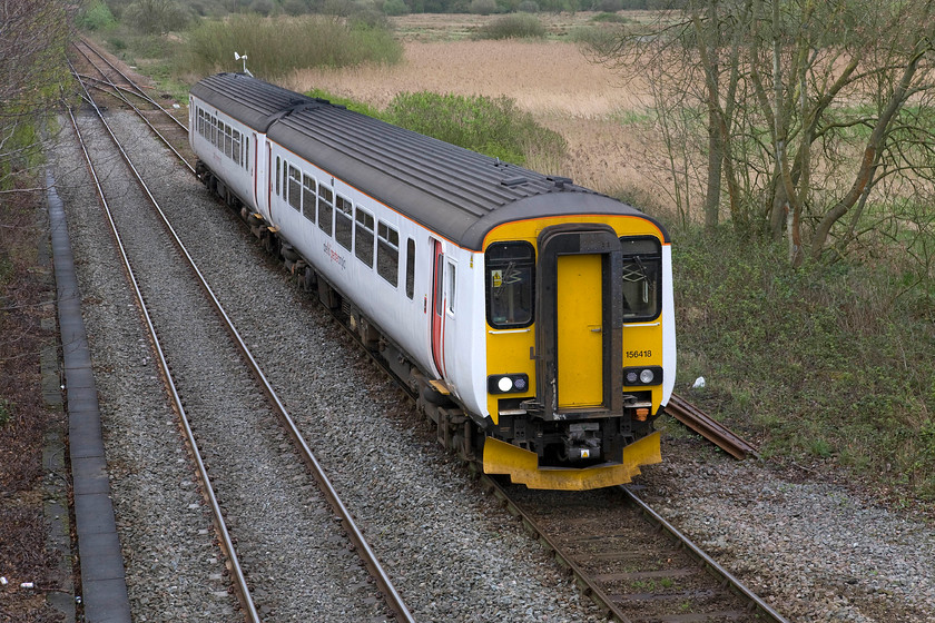 156418, LE 11.46 Sheringham-Norwich (2S13), Whitlingham Lane crossing TG266083 
 156418 rejoins the mainline at Whitlingham Junction working the 11.46 Sheringham to Norwich 2S134 Greater Anglia service. Notice the mini wind turbine and solar panel attached to the post level with the rear of the train. This was used to provide additional power to control the electronics at the junction. 
 Keywords: 156418 11.46 Sheringham-Norwich 2S13 Whitlingham Lane crossing TG266083 Abellio Greater Anglia