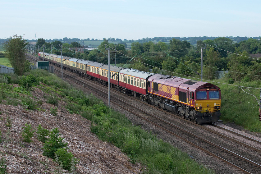 66083 & 66078, outward leg of The Curvey Weaver, 06.42 London Euston-Garston FLT (1Z78), Milton Malsor SP738560 
 The sky in the background should have meant that this train was bathed in lovely early summer sunshine. However, there was a stubborn and virtually complete bank of cloud behind and to the left that blocked out the sun so the train remains poorly lit! The 1Z78 Curvey Weaver railtour approaches Northampton past Milton Malsor on its outward leg that left Euston at 06.42. 66083, still in its old EWS livery and branding, leads the train that would end up at Graston Freightliner terminal via various odd and rare sections of track. 66078, resplendent in its new bright red DB livery, brings up the rear of the train that is entirely composed of twelve superb Mk. I coaches. 
 Keywords: 66083 66078 The Curvey Weaver 06.42 London Euston-Garston FLT 1Z78 Milton Malsor SP738560