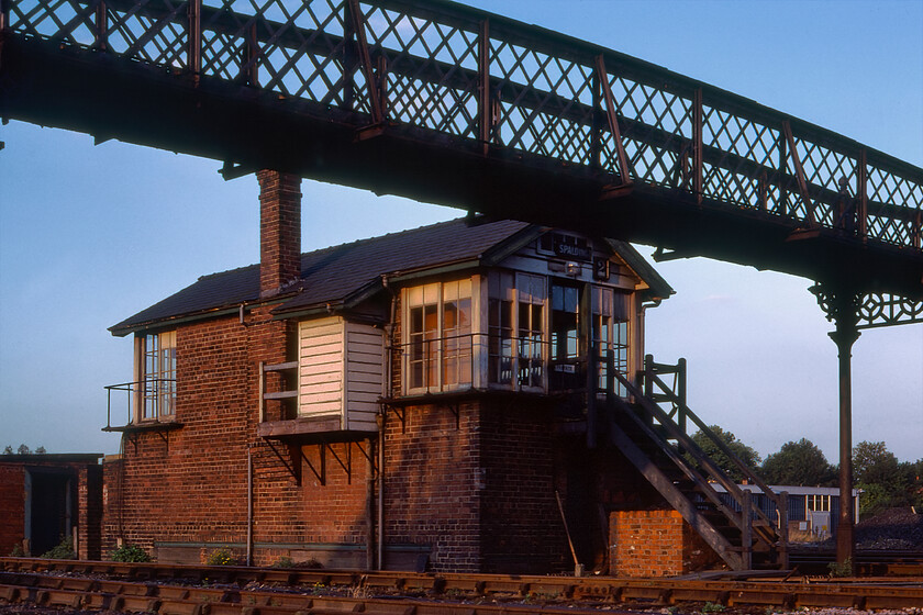 Spalding no.2 signal box (GN, 1920) 
 My final picture of the day before heading back to our campsite next to the ECML at Essendine is a rear view of the Great Northern Spalding Number 2 signal box catching the evening sunshine. Framed by the latticed Steppingstone footbridge the box wears a pair of, what I believe to be, LNER blue enamels above the door identified by the font but I stand to be corrected. The box survived for a further three years before considerable rationalisation took place in Spalding with all control moving to Number 1 box located at the towns busy level crossing. 
 Keywords: Spalding no.2 signal box GN 1920