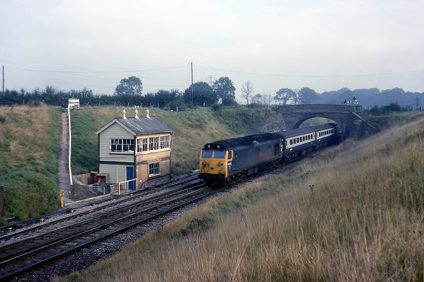 50042, 07.30 London Paddington-Penzance (1B24), Clink Road Junction 
 With this slightly misty and soft morning light, it can only autumn! 50042 'Triumph' heads west with the 07.30 1B24 Paddington to Penzance. The train is seen passing Clink Road Junction signal box with the pointwork for the actual junction to the left of the image. Whilst the junction that takes the line into Frome is still very much in use, this spot is totally unrecognisable today with everything, including the typical GWR stone bridge, having been swept away with the box succumbing in October 1984. 
 Keywords: 50042 07.30 London Paddington-Penzance 1B24 Clink Road Junction