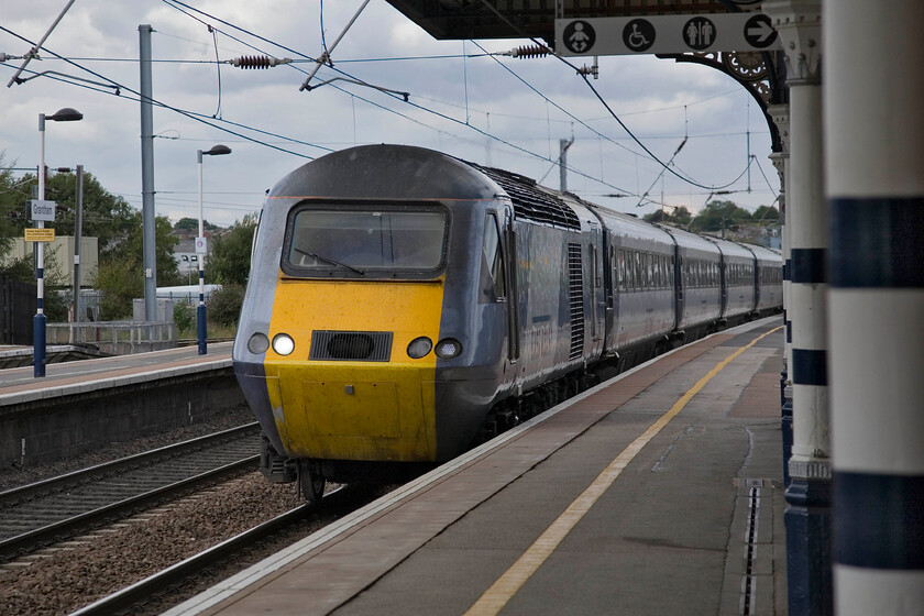 Class 43, GR 07.52 Aberdeen-London King's Cross (1E11), Grantham station 
 Taken from the up platform at Grantham station the 07.52 Aberdeen to King's Cross East Coast service passes at speed. Unfortunately, with no front number visible I have been unable to identify the leading power car. 
 Keywords: Class 43 07.52 Aberdeen-London King's Cross 1E11 Grantham station East Coast HST