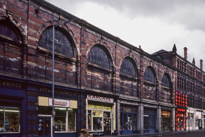 Former LNER goods depot, Deansgate, Manchester 
 A second view of the former LNER goods depot in Manchester's Deansgate. This vast rail connected goods and exchange depot was opened in 1899 and was constructed to a very high specification including it being 'fireproof'. With the general decline in freight services on the railways, eventual closure came in 1954 with it becoming very dilapidated until restoration rescued it from the brink. It is now the home to a number of bars, restaurants, shops and a multiplex having become an attraction in its own right. Notice that all the retailers occupying the building in this view are involved in car spares and accessories including one selling exclusively motoring books! 
 Keywords: Former LNER goods depot Deansgate Manchester