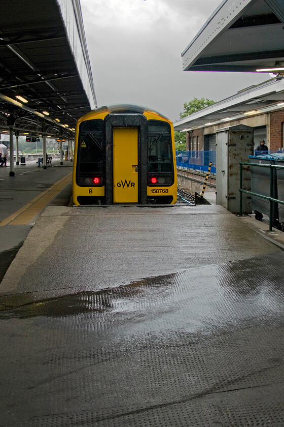 158768, stabled, former Motorail ramp, Bristol Temple Meads station 
 GWR's 158768 is seen stabled under a dark rain-leaden sky. The unit is at the far western side of Temple Meads in what is officially called Bristol TM Plat 2 Motorail according to RTT. The rather primitive concrete ramp in the foreground was used by drivers to gain access to the Motorail flats that would have been marshalled into the bay platform. With the forthcoming redevelopment and transformation of this part of the station, I suspect that this ramp will be removed sometime soon. 
 Keywords: 158768 former Motorail ramp Bristol Temple Meads station GWR