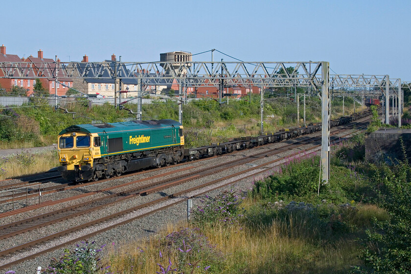 66506, 12.56 Southampton MCT-Trafford Park (4M61, RT), site of Roade station 
 Another diverted Freightliner passes Roade led by 66506 'Crewe Regeneration'. Normally the 12.56 Southampton MCT to Trafford Park would be passing through the picturesque Cherwell Valley but due to the disruption caused by the construction of a new bridge just south of Oxford station, it is off-route. It makes things more interesting for us enthusiasts to see services such as 4M61 but as for the travelling public of Oxford, I am not so sure! 
 Keywords: 66506 12.56 Southampton MCT-Trafford Park 4M61 site of Roade station Freightliner Crewe Regeneration